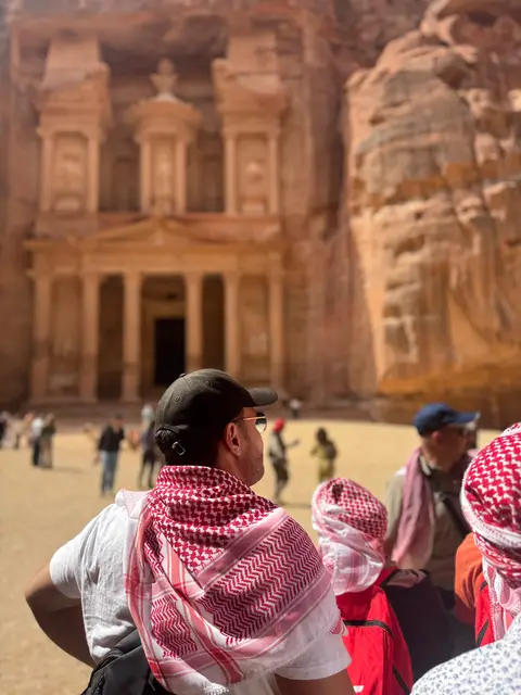 Pèlerin en keffiyeh contemplant le Trésor de Pétra en arrière-plan