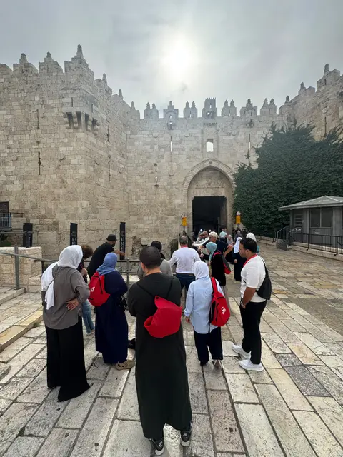 Groupe de pèlerins devant la Porte de Damas dans la vieille ville de Jérusalem